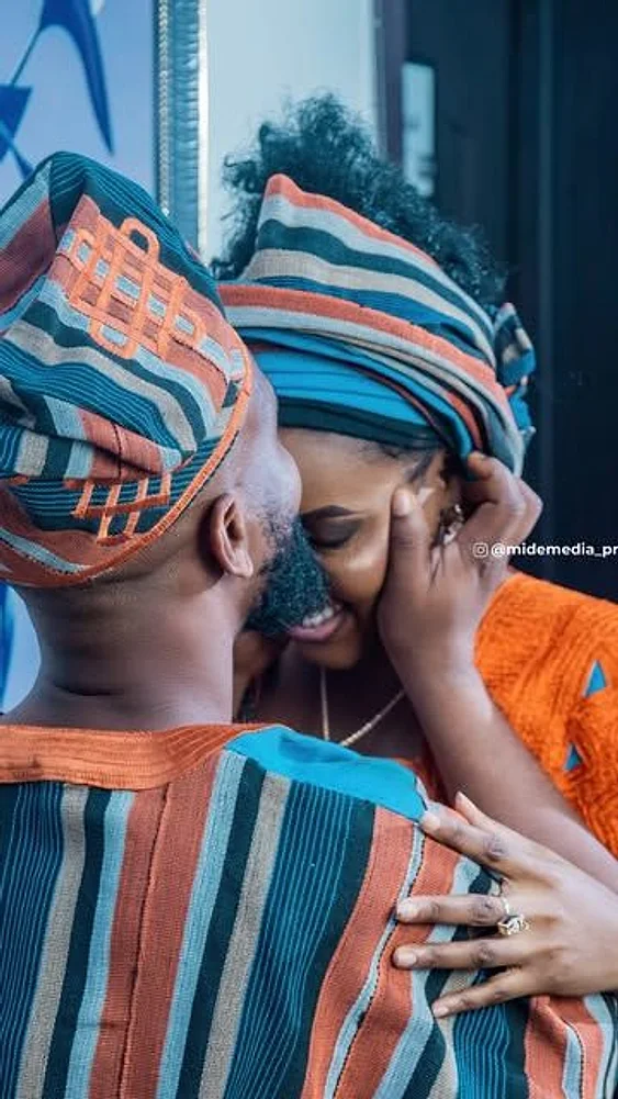 Couple in traditional Yoruba wedding attire sharing a quiet moment