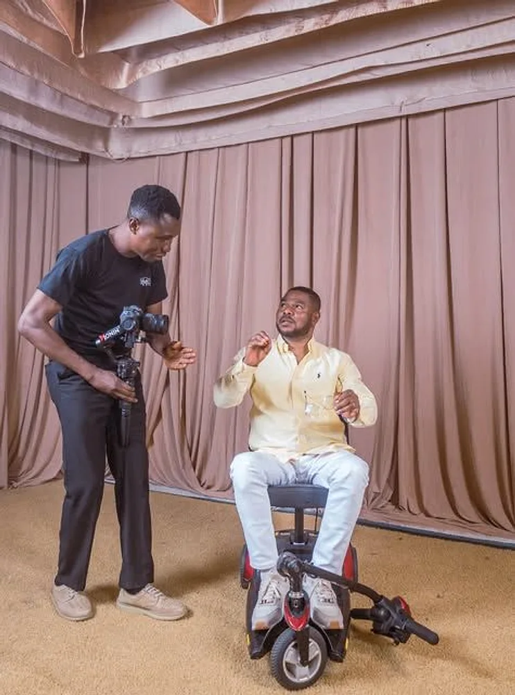 Director Mide filming an interview with a camera on a gimbal